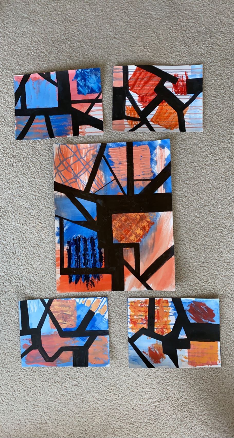 A series of abstract paintings arrayed in an I formation